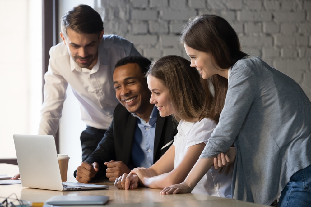 Smiling,Diverse,Employees,Or,Students,Team,Watching,Webinar,On,Laptop